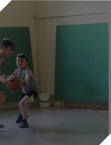 Two young boys playing basketball